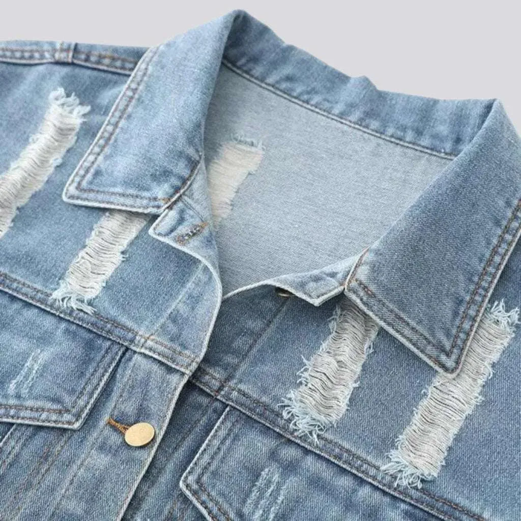 Fully distressed women's denim jacket